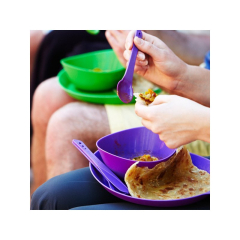 Cilvēki ēd brīvā dabā, izmantojot Lifeventure Flexibowl kempinga bļodas